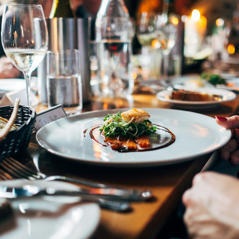 A restaurant table set with food, warmly lit for dinner service.